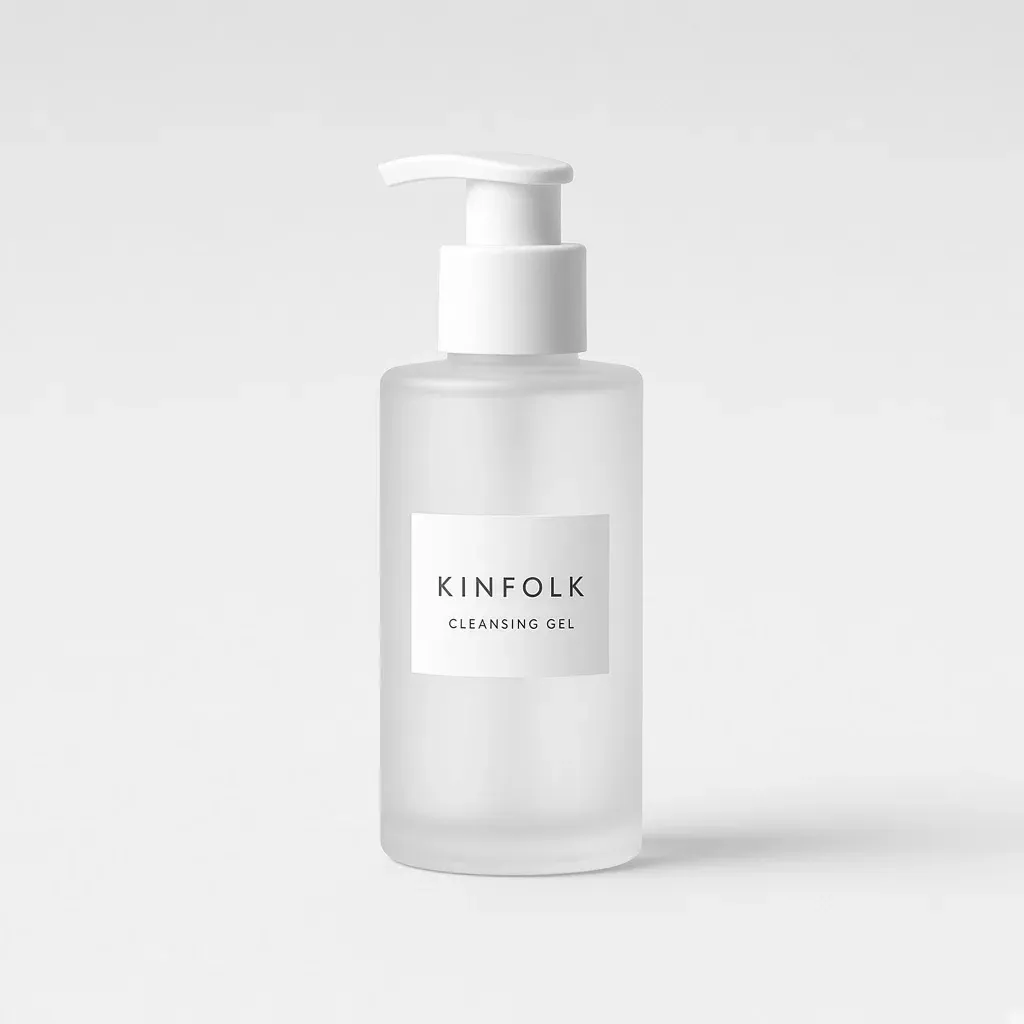 Frosted glass pump bottle with a white label reading Kinfolk cleansing gel