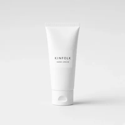 White squeeze tube with a label reading Kinfolk hand cream
