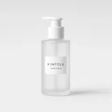 Frosted glass pump bottle with a white label reading Kinfolk hand wash