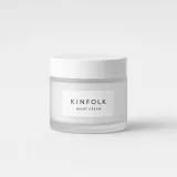 Frosted glass jar with a white lid and a label reading Kinfolk night cream