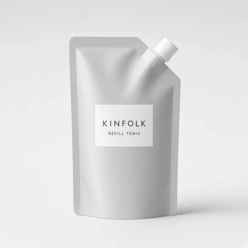 Aluminium refill pouch with a white spout and a label reading Kinfolk refill tonic
