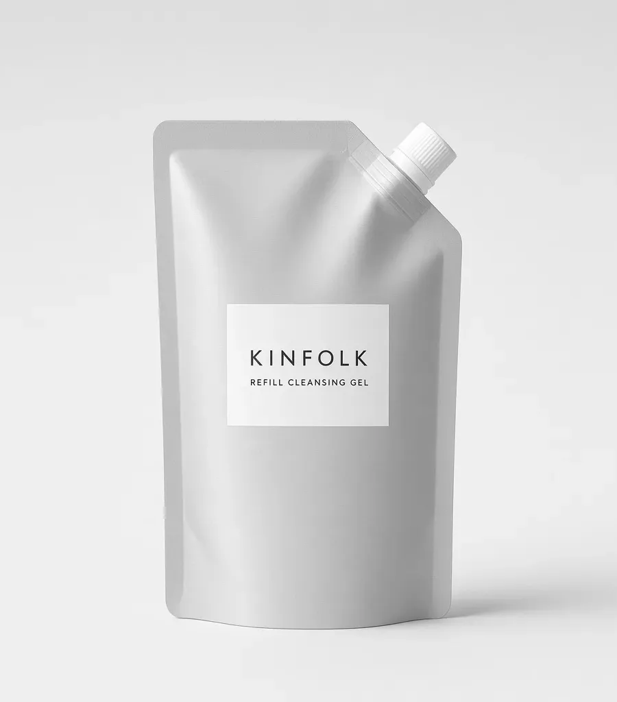 Aluminium refill pouch with a white spout and a label reading Kinfolk refill cleansing gel