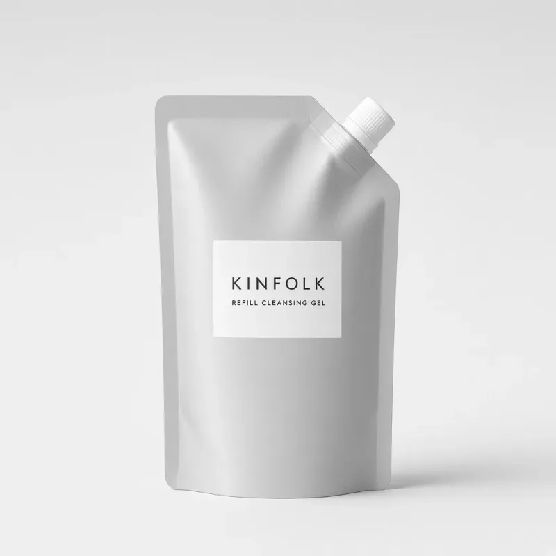 Aluminium refill pouch with a white spout and a label reading Kinfolk refill cleansing gel