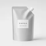 Aluminium refill pouch with a white spout and a label reading Kinfolk refill hand wash