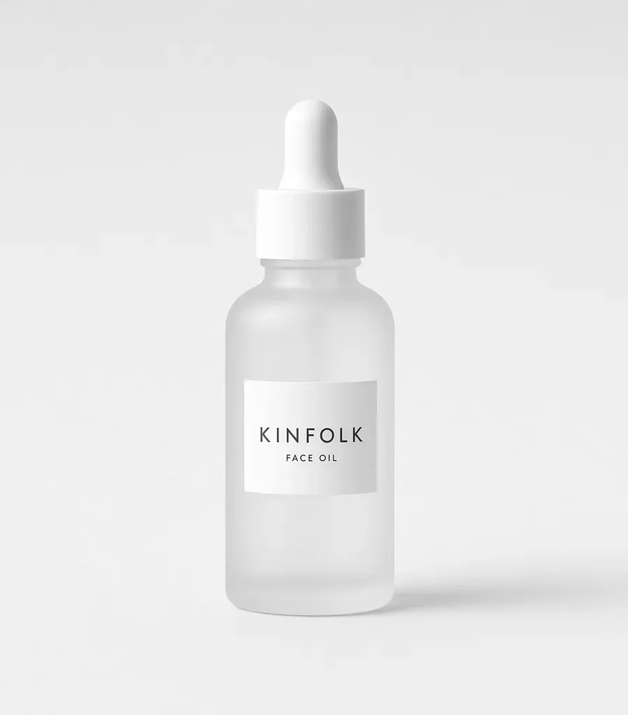 Frosted glass dropper bottle with a white label reading Kinfolk face oil