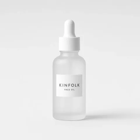 Frosted glass dropper bottle with a white label reading Kinfolk face oil