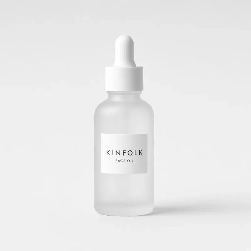 Frosted glass dropper bottle with a white label reading Kinfolk face oil
